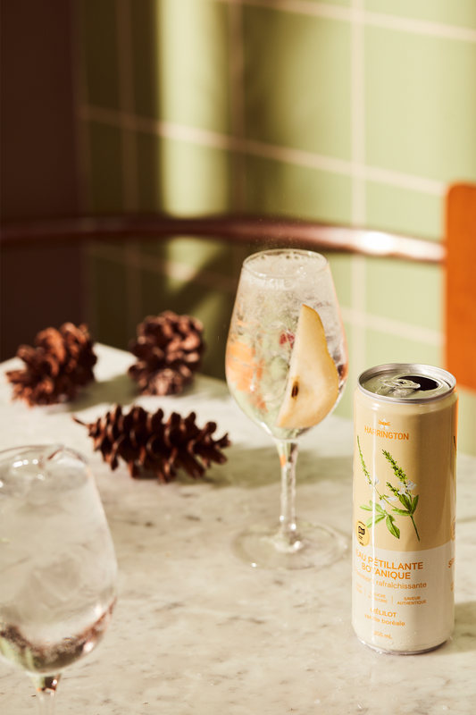 Tranquille cocktail made with still cider, apple and pear juice, and Harrington botanical sparkling water, served with pear slice and thyme.